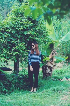 Woman Hipster with sunglasses Fashion Style Lifestyle Concept, wearing a black and white striped t-shirt.の写真素材