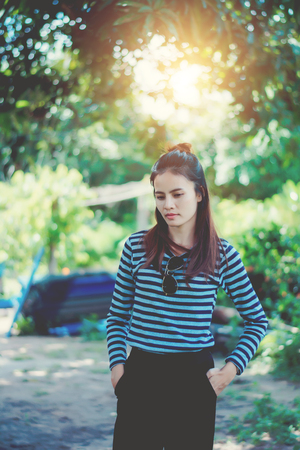 Woman Hipster with sunglasses Fashion Style Lifestyle Concept, wearing a black and white striped t-shirt.の写真素材