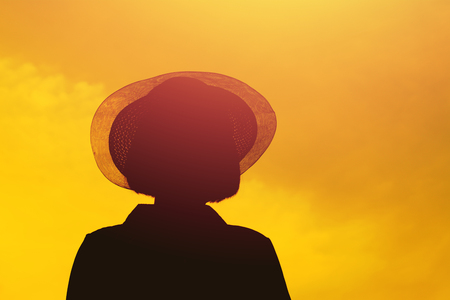 Silhouette of woman  on sunset background with freedom mood.の写真素材