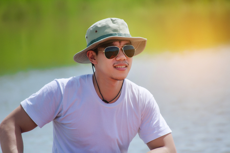 Fishing man with his boat on the river.の写真素材