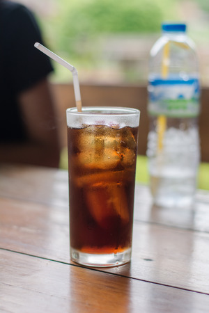 Soft drink with ice in the glass on a table.の写真素材