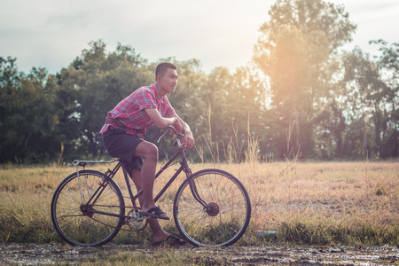 Asian men wear traditional dresses  with old bikes.の写真素材