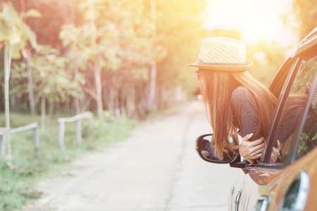 Happy young woman looking out of car window,Toward adventure,relaxing and enjoying road trip.の写真素材