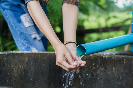Woman construction worker,Repairing a broken water pipe in garden.の写真素材