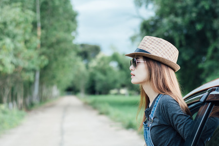 Happy young woman looking out of car window,Toward adventure,relaxing and enjoying road trip.の写真素材
