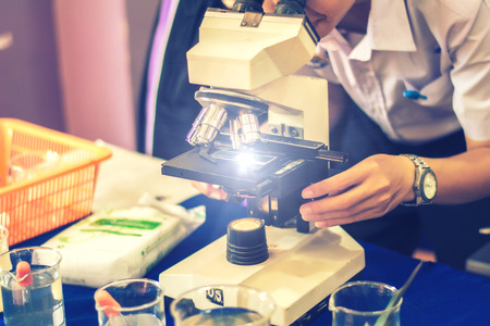 Students are microscopic learning science in class.