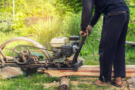 Man cutting wood with a innovation machine.の写真素材