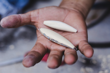 Hand made fishing lures. Making handcrafted fishing lures made of wood.