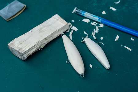Hand made fishing lures. Making handcrafted fishing lures made of wood.の写真素材