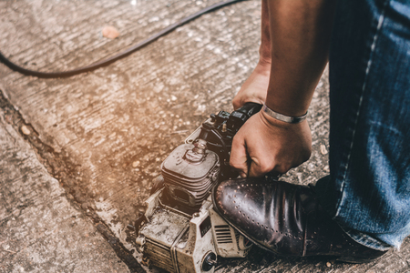 A mechanic is old engine repair.Can be used again.の写真素材