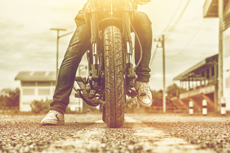 Young man drive with motorbike on street, enjoying freedom and active lifestyle, having fun on a bikers tour.の写真素材
