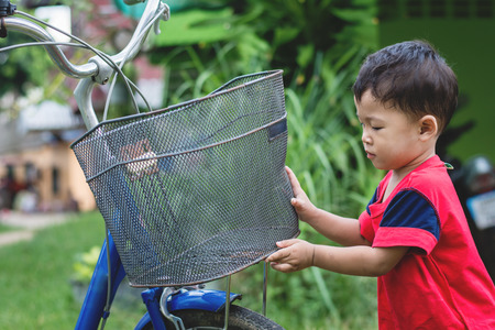 Happy children playing with a bike alone.の写真素材