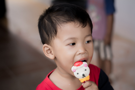 Children eating ice cream in the summer.の写真素材