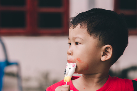 Children eating ice cream in the summer.の写真素材