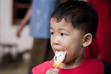Children eating ice cream in the summer.の写真素材
