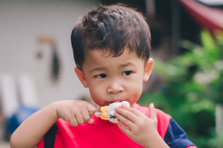 Children eating ice cream in the summer.の写真素材