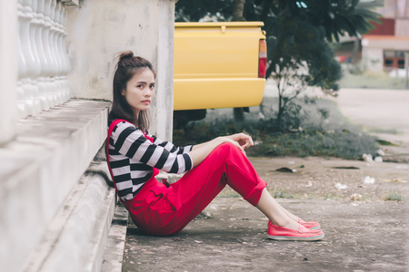 Close up portrait of hipster woman with her yellow car.の写真素材