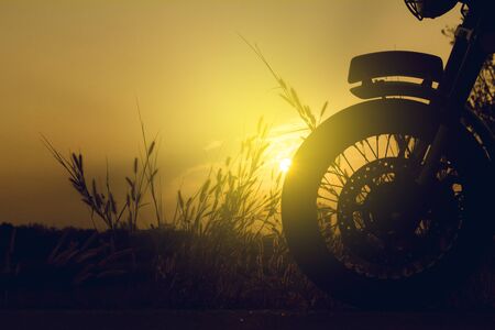 Cose-up silhouette of motorbike on sunset background,Enjoying freedom and active lifestyle.の写真素材