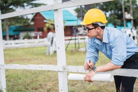 Man architect standing to think and plan directing design work at farm.Outdoor working concept.の写真素材