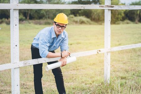 Man architect standing to think and plan directing design work at farm.Outdoor working concept.の写真素材