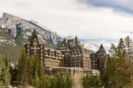 Banff, Alberta, Canada, March 14, 2021: Fairmont Banff Spring, the famous historic hotel in Banff National Park with couple of rocky peaks in the backgroundのeditorial素材