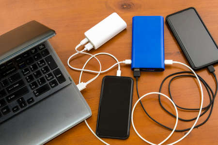 Wireless devices are recharged at the same time from couple of power banksの写真素材