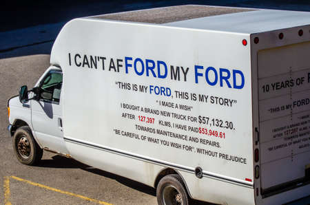 Calgary, Alberta, Canada, October 24, 2021: a Ford truck in a parking lot close to downtown with a frustrated message on it.のeditorial素材