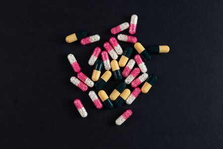 Some drugs and capsules on a black backgroundの写真素材
