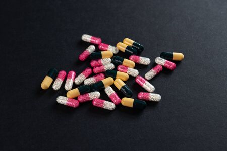 2 types drugs and capsules on a black backgroundの写真素材