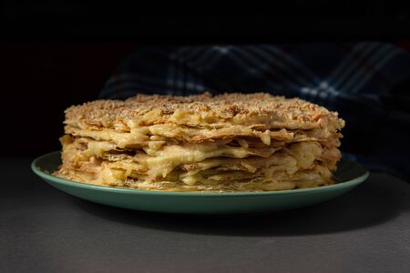 hand made delicious Napoleon cake with custard in a sprinkle of cakes