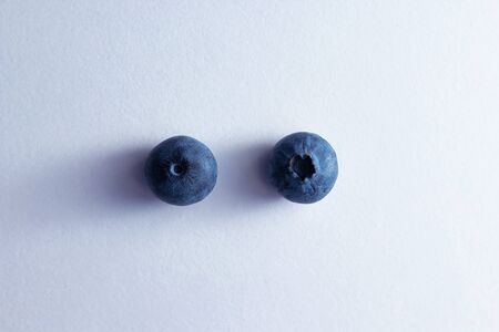 a pair of blueberries on a white backgroundの写真素材