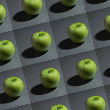 still life ripe fresh green granny apple on a gray background patternの写真素材