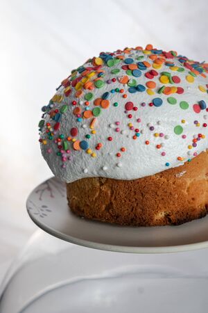 Easter cake close-up: white icing and colored sweet decorations