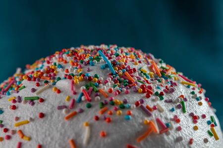 Easter cake close-up: white icing and colored sweet decorations