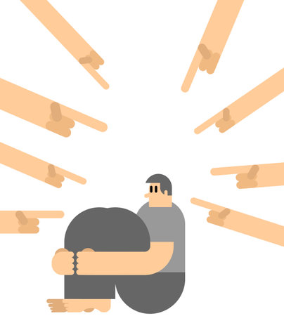 Victim blaming. Sad guy sits and is afraid. Fingers point at the person. Victim blaming conceptのイラスト素材