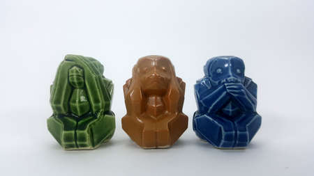 Model of a ceramic monkey with ears closed eyes closed on white backgroundの写真素材