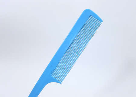 Blue comb and white backdropの写真素材