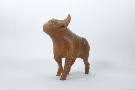 Carved wooden bull and white backdropの写真素材