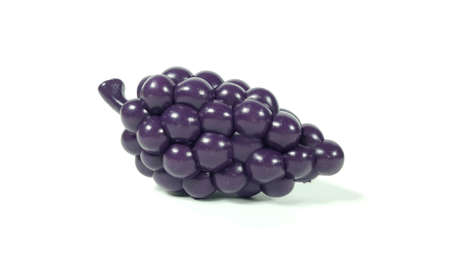 Plastic toy grapes And a white backdropの写真素材