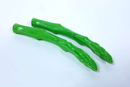 Plastic toy asparagus And a white backdropの写真素材