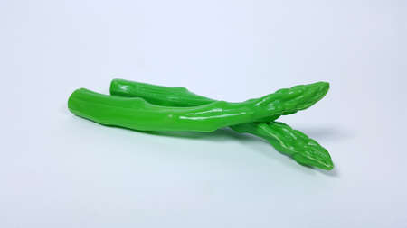 Plastic toy asparagus And a white backdropの写真素材