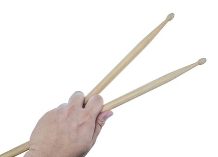 Isolated male left hand holding drum sticks on white backgroundの写真素材