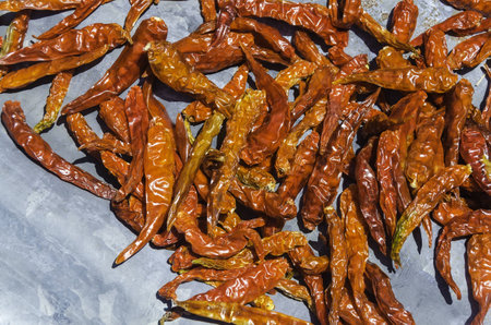 Dried red chili peppers background on plateの写真素材