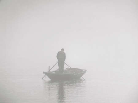 Fisherman in the fogの写真素材