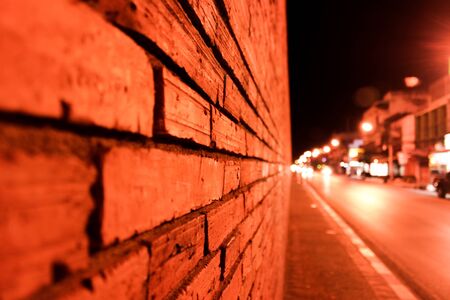 masonry brick wall at night streetの写真素材