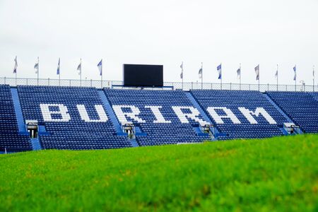 Navy blue amphitheater in football arena with green football pitchの写真素材