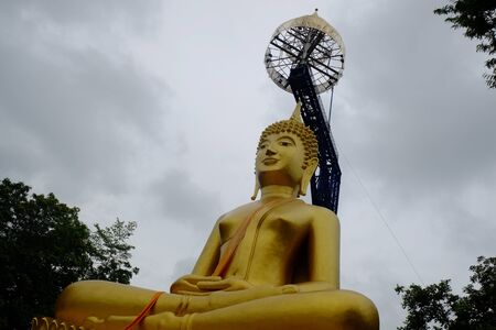 golden buddha with steel structureの写真素材
