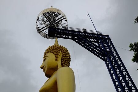 golden buddha with steel structureの写真素材