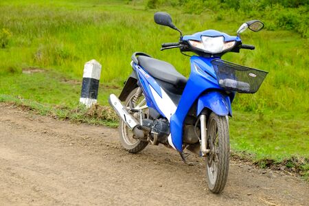 blue motorcycle on the country roadの写真素材