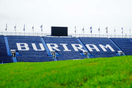 Navy blue amphitheater in football arena with green football pitchのeditorial素材